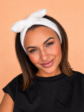 White bow headband worn during self tan routine