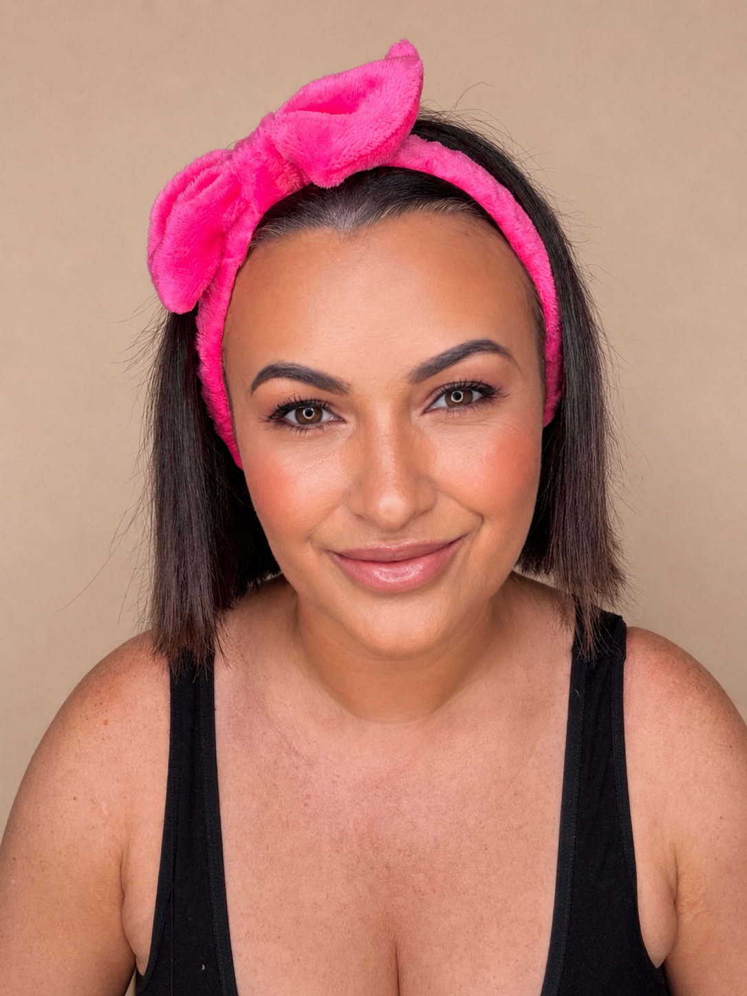 Hot pink bow headband worn on model